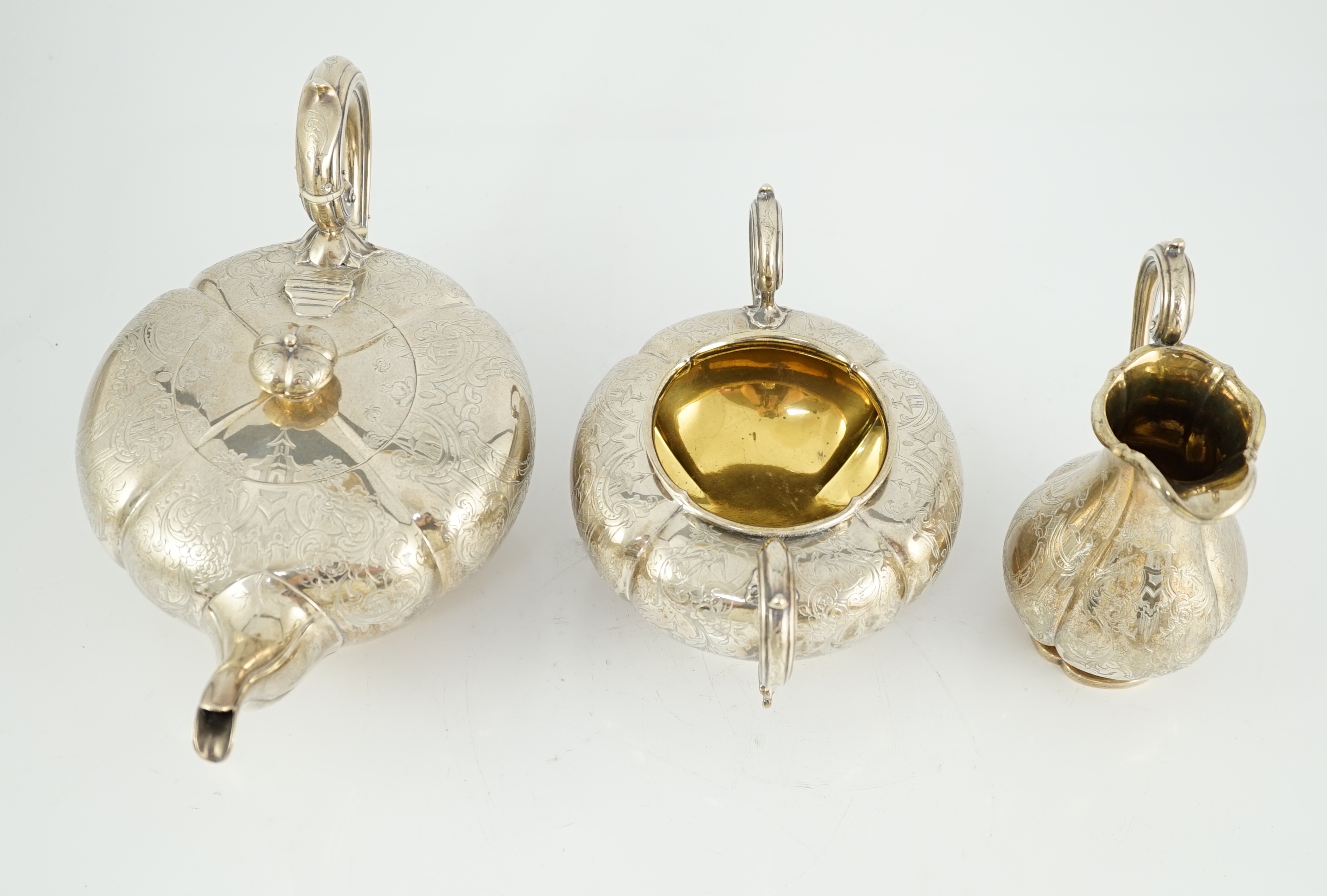 A Victorian silver three piece melon shaped tea set, by Charles Reily & George Storer